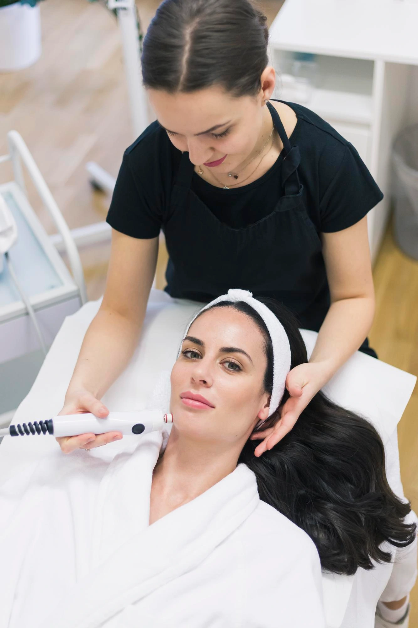 Woman receiving a professional medspa facial treatment representing regenerative aesthetics, skin health, and wellness-focused care through The Sante Method.